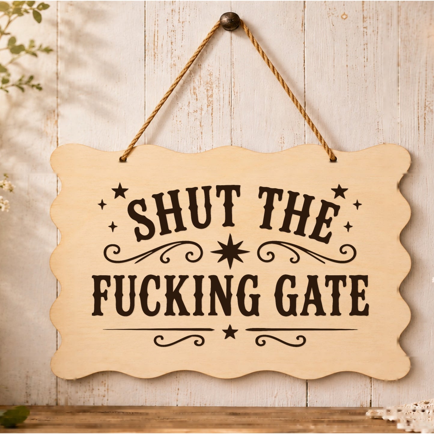 Shut the F**king Gate wooden plaque displayed by a garden gate