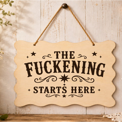 The F**kening Starts Here wooden plaque displayed in a home setting