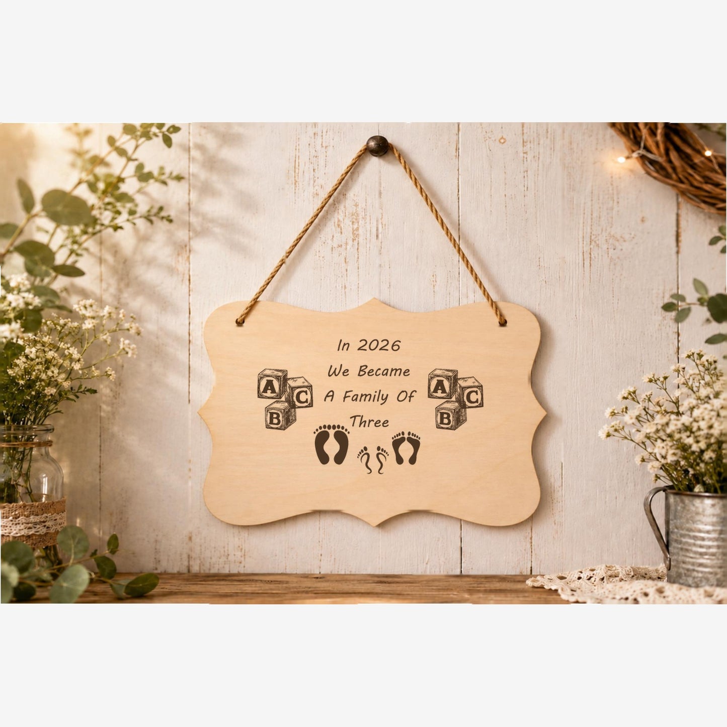 In 2026 We Became a Family of 3 plaque displayed in a family home setting