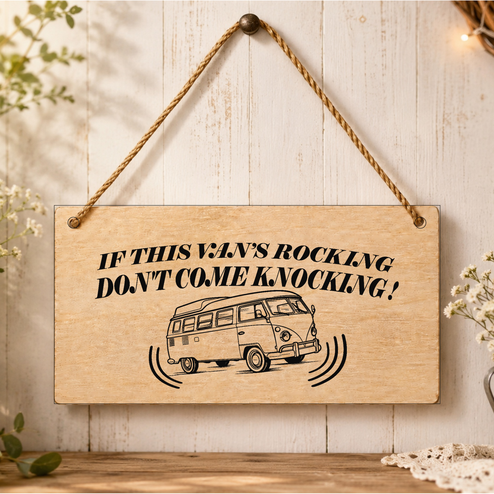 If the Van’s Rocking wooden plaque displayed in a campervan setting