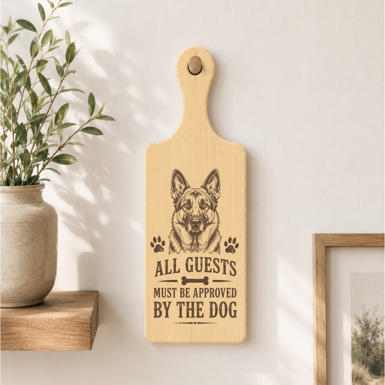 All Guests Must Be Approved By The Dog plaque displayed in a home setting