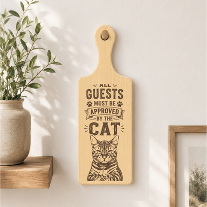 All Guests Must Be Approved By The Cat plaque displayed in a home setting