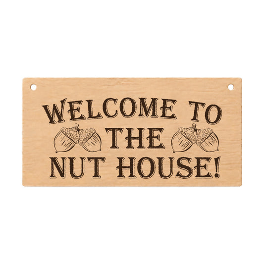 Welcome to the Nut House funny wooden plaque on a white background