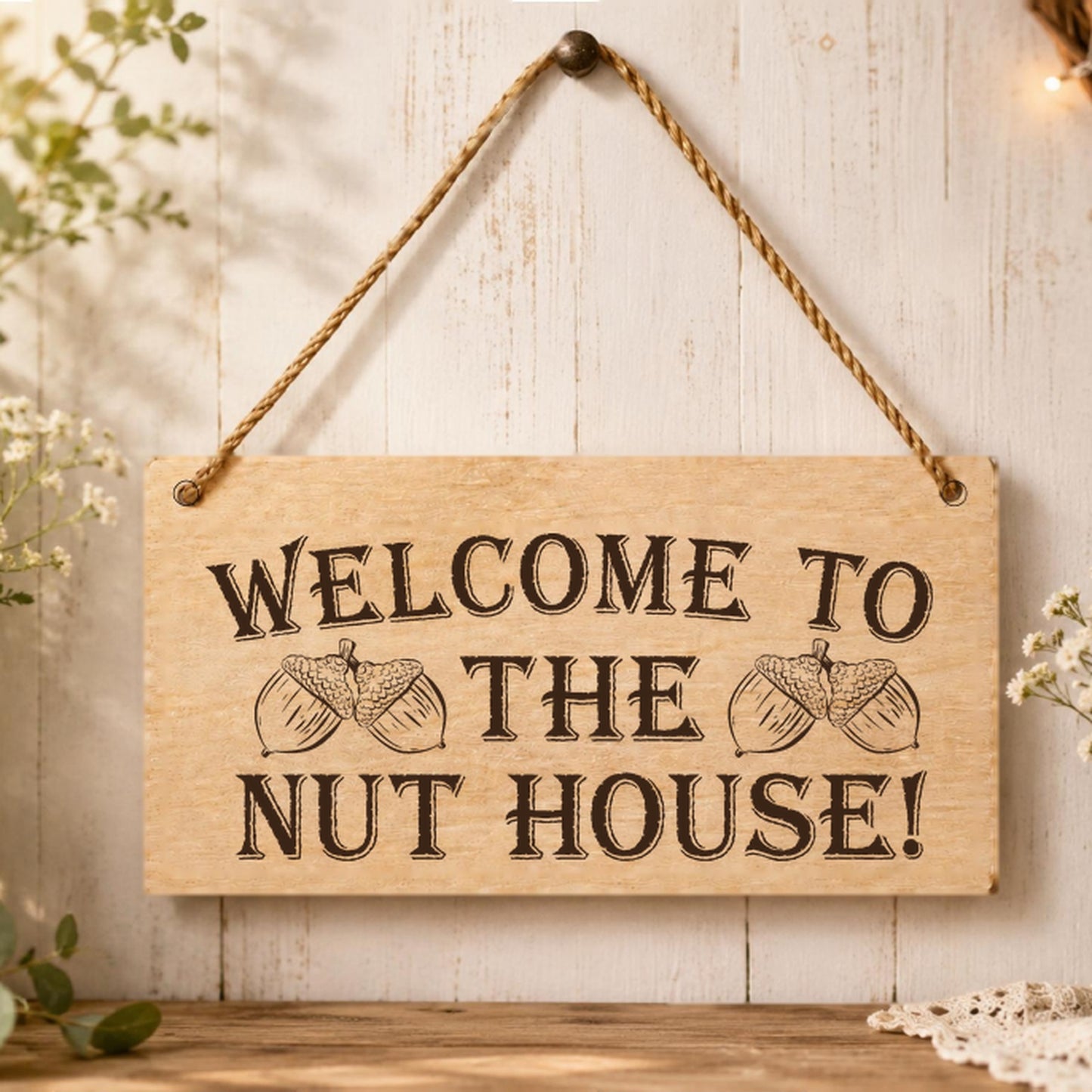 Welcome to the Nut House plaque displayed in a family home setting