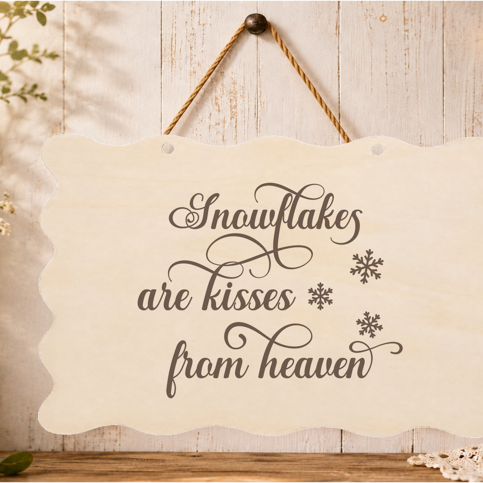 Snowflakes are kisses from heaven memorial plaque hanging on a wall