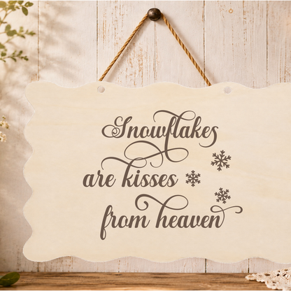 Snowflakes are kisses from heaven memorial plaque hanging on a wall