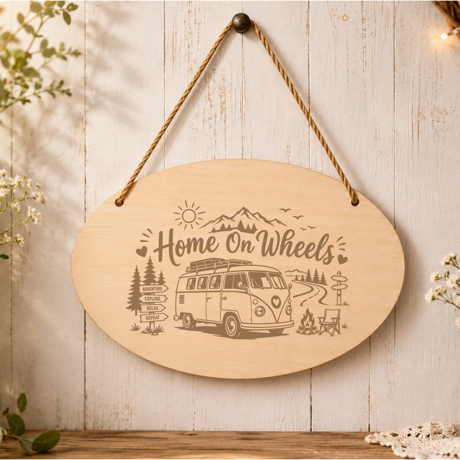 Home on Wheels oval wooden plaque displayed in a caravan setting