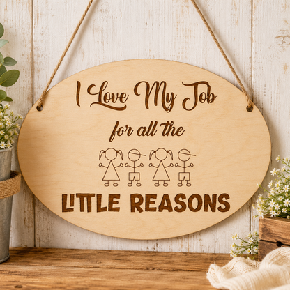 I Love My Job for the Little Reasons plaque displayed in a workplace setting