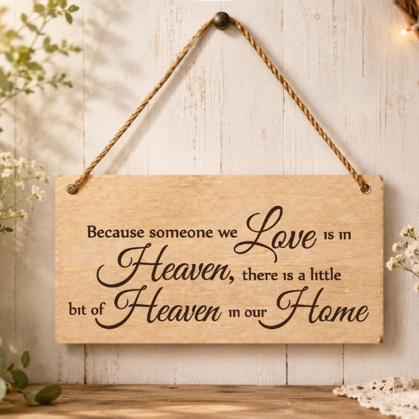Because Someone We Love Is In Heaven plaque displayed in a remembrance setting