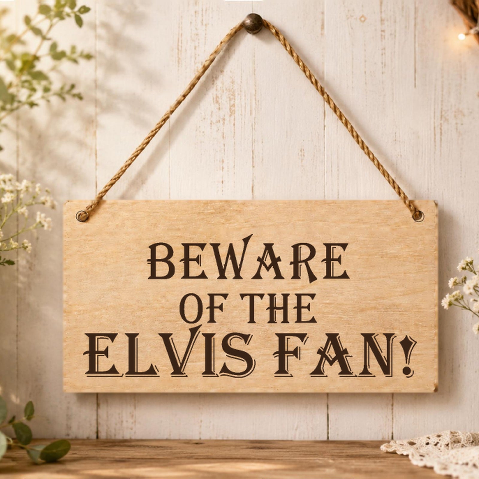Beware of the Elvis Fan wooden plaque displayed in a music room setting