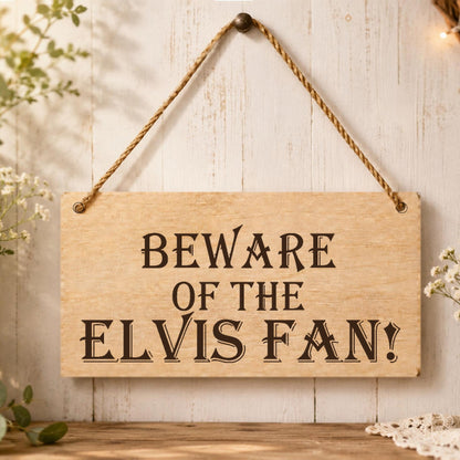 Beware of the Elvis Fan wooden plaque displayed in a music room setting