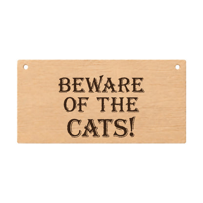 Beware of the Cats funny laser engraved wooden plaque on a white background