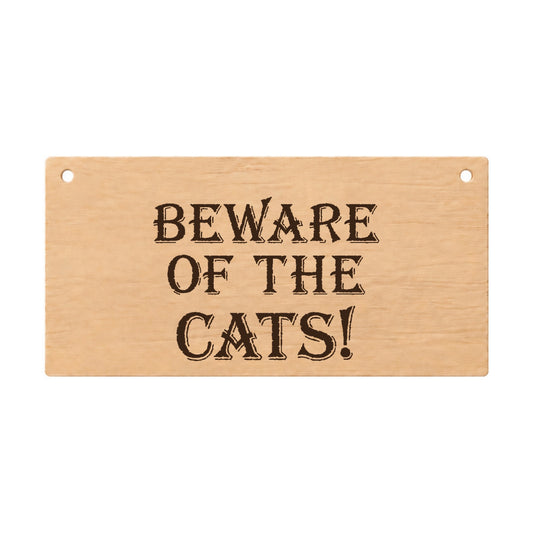 Beware of the Cats funny laser engraved wooden plaque on a white background