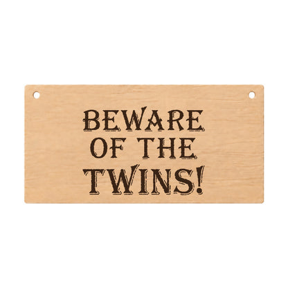 Beware of the Twins funny laser engraved wooden plaque on a white background