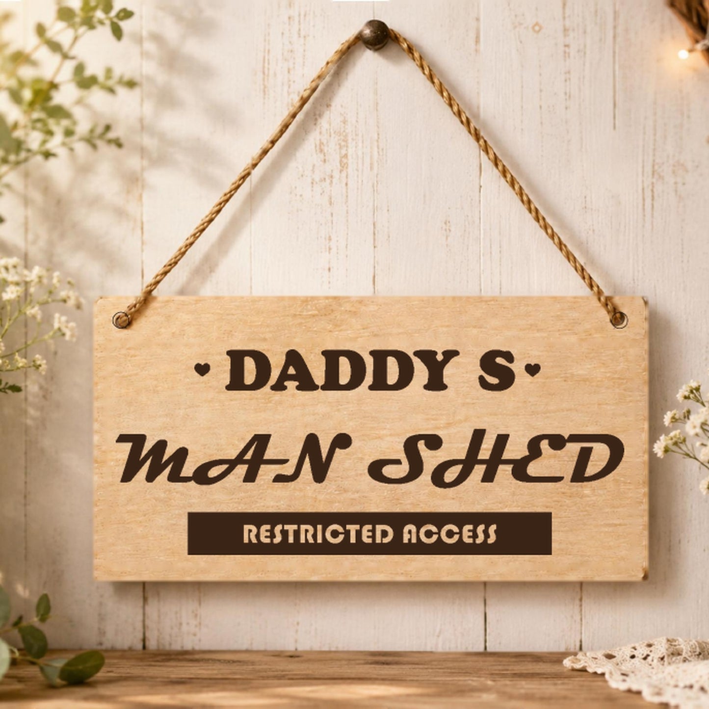 Daddy's Man Shed wooden plaque displayed in a shed setting